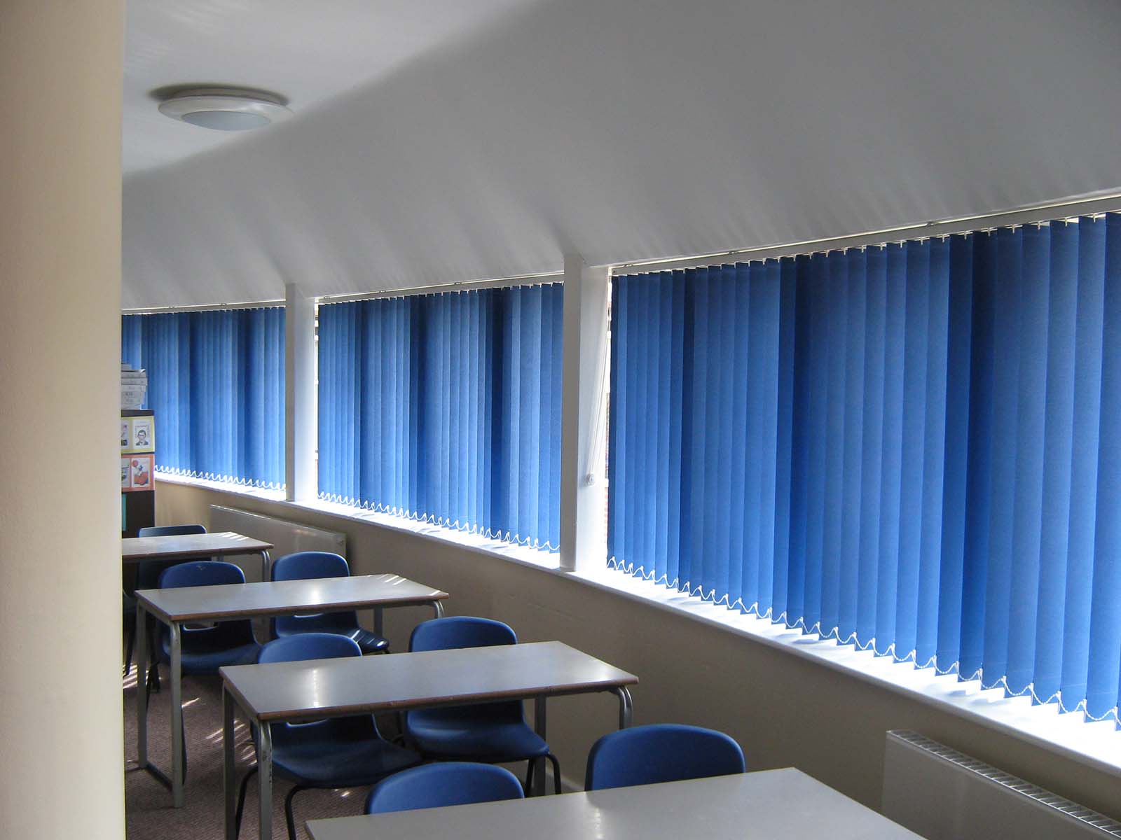 vertical blue blinds in classroom